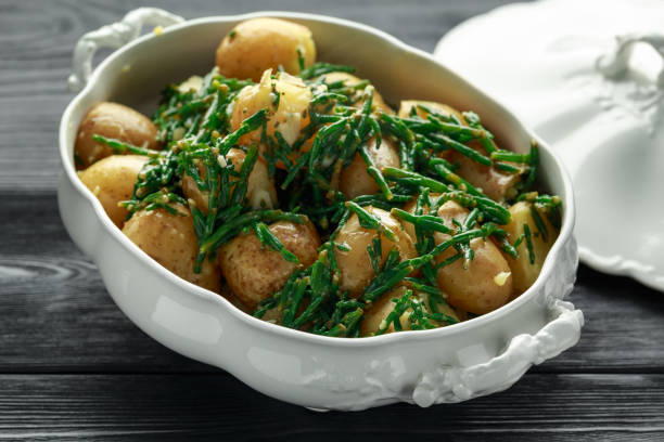 Boiled new potato with fresh samphire and garlic Boiled new potato with fresh samphire and garlic. salicornia europaea stock pictures, royalty-free photos & images