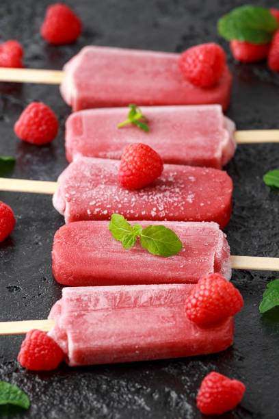 istock Homemade raspberry popsicles, ice lolly on rustic black background 1143530145