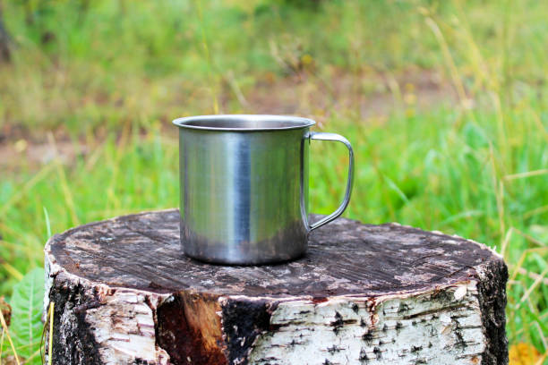 istock Metal mug on the stump 1143530215