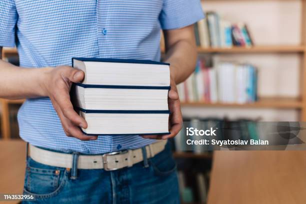 Male Hands Holding A Stack Of Books Stock Photo - Download Image Now - Advice, Angle, Arm