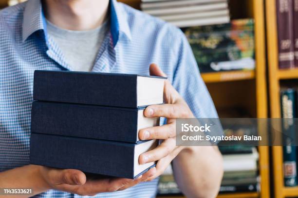 Male Hands Holding A Stack Of Books Stock Photo - Download Image Now - Book, Spine - Body Part, Advice