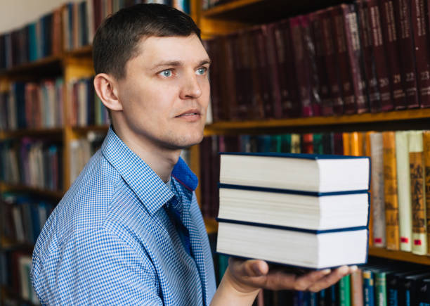 istock Stack of books lying on the palm 1143533638