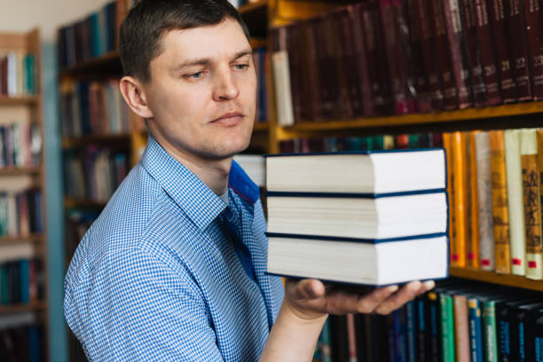 istock Stack of books lying on the palm 1143533646