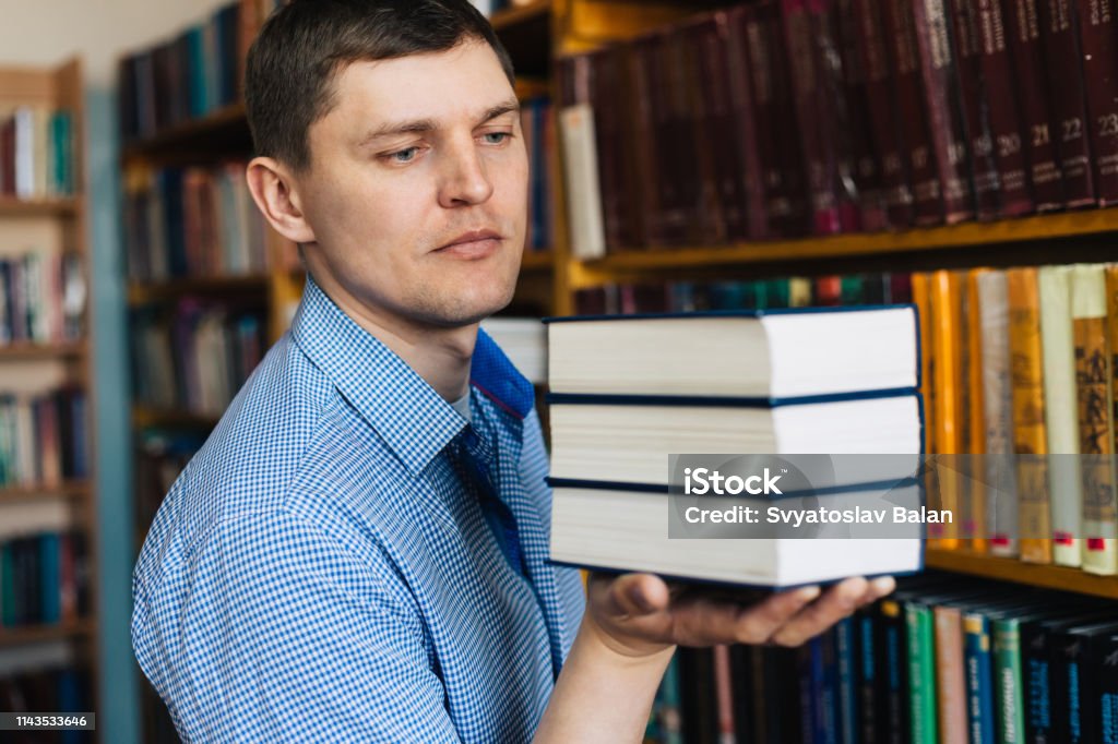 Stack of books lying on the palm Advice Stock Photo