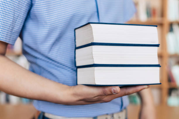 istock Stack of books lying on the palm 1143533741