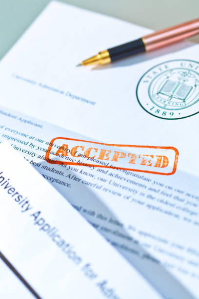 istock University Application Acceptance Letter Still Life with Rubber Stamp of ACCEPTED 1143533760