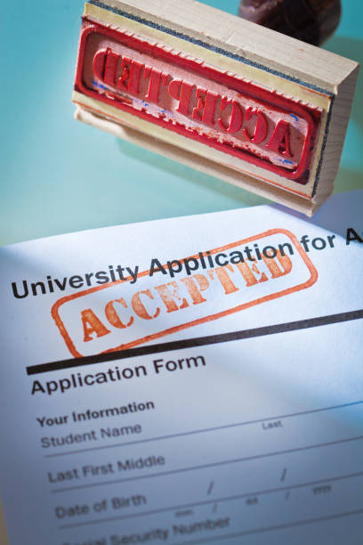istock University Application Acceptance Letter Still Life with Rubber Stamp of ACCEPTED 1143533768