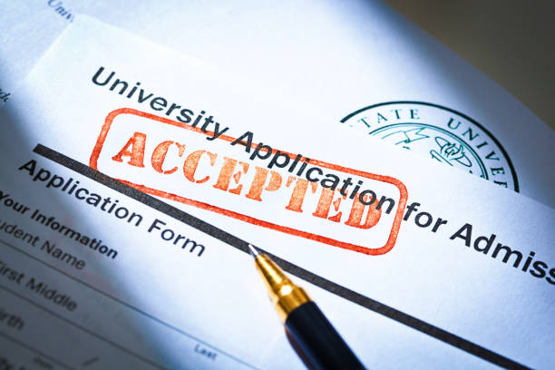 istock University Application Acceptance Letter Still Life with Rubber Stamp of ACCEPTED 1143533769