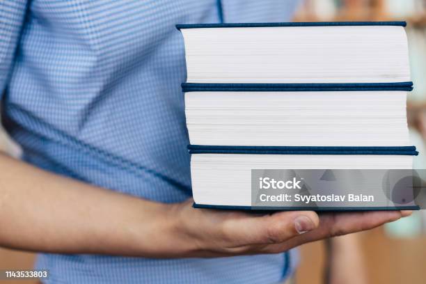 Stack Of Books Lying On The Palm Stock Photo - Download Image Now - Advice, Angle, Arm