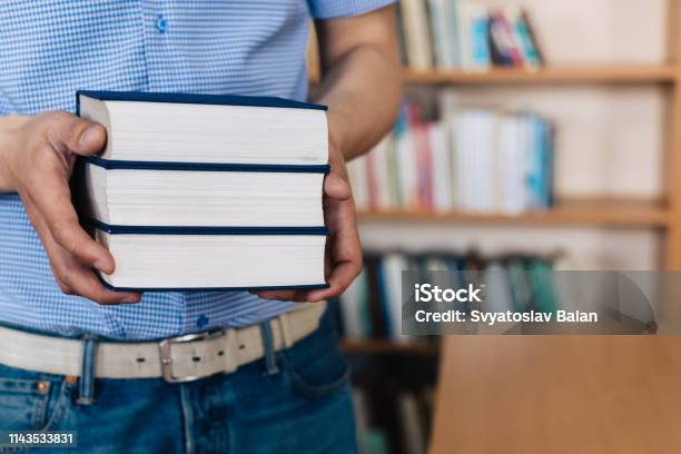 Male Hands Holding A Stack Of Books Stock Photo - Download Image Now - Advice, Angle, Arm