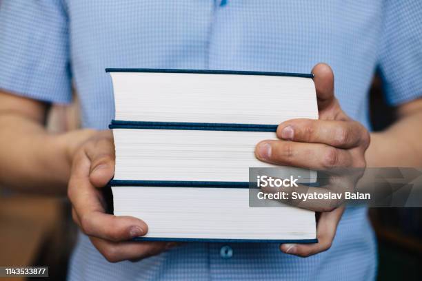 Male Hands Holding A Stack Of Books Stock Photo - Download Image Now - Book, Hand, Heap