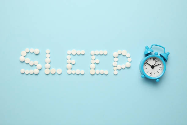istock Sleeping pills and an alarm clock, insomnia concept. Night depression, anxiety 1143534288