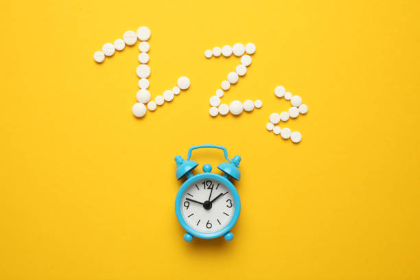 istock Sleeping pills and an alarm clock, insomnia concept. Trouble falling asleep 1143534293