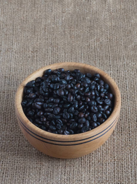 istock Roasted wild coffee in a wooden bowl. 1143535416