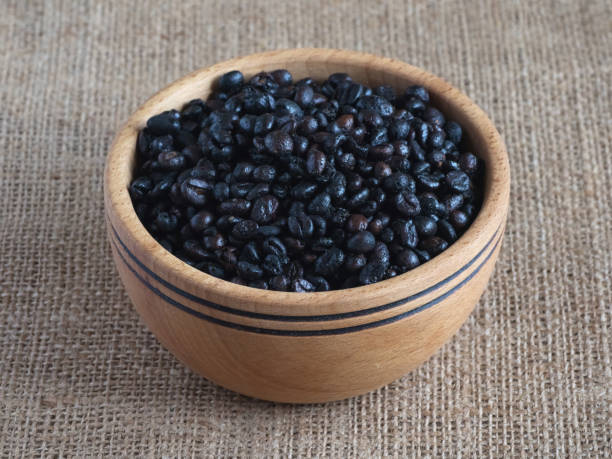 istock Roasted wild coffee in a wooden bowl. 1143535506