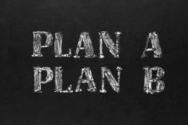 istock Planning concept. Handwritten white chalk plan A and B on blackboard 1143535619