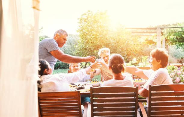 istock Three generations one family  have dinner in summer garden 1143535770