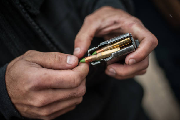 istock Soldier hands load rifle machine gun bullets into cartridge clip 1143535838