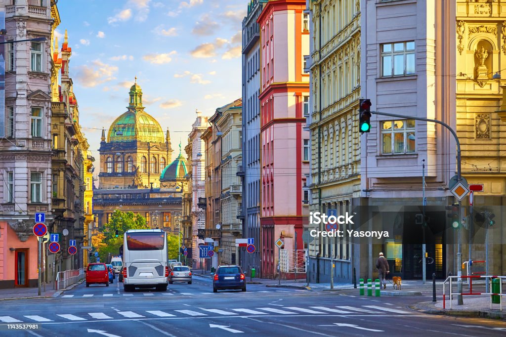 Street in Prague, Czech Republic. Cityscape Street in Prague, Czech Republic. Cityscape with road and view at dome of national museum building. Transport and bus at crossroad. Dawn early morning in centre of city. Prague Stock Photo