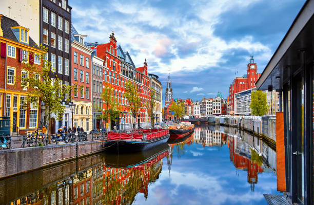 Channel in Amsterdam Netherlands houses river Amstel Channel in Amsterdam Netherlands houses river Amstel landmark old european city spring landscape. amsterdam stock pictures, royalty-free photos & images