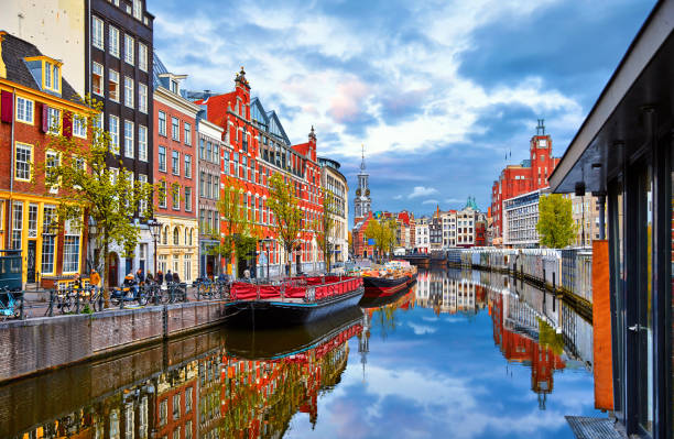 Channel in Amsterdam Netherlands houses river Amstel Channel in Amsterdam Netherlands houses river Amstel landmark old european city spring landscape. netherlands photos stock pictures, royalty-free photos & images