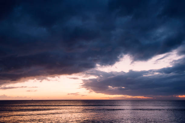 istock spectacular sunset on a beach with stormy sky 1143540432