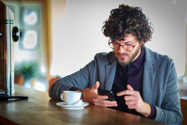 istock Man sitting in the coffee shop and using smart phone 1143542992