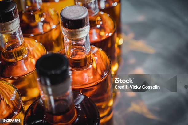 Bottles Of Strong Liquors In Production Stock Photo - Download Image Now - Rum, Alcohol - Drink, Whiskey