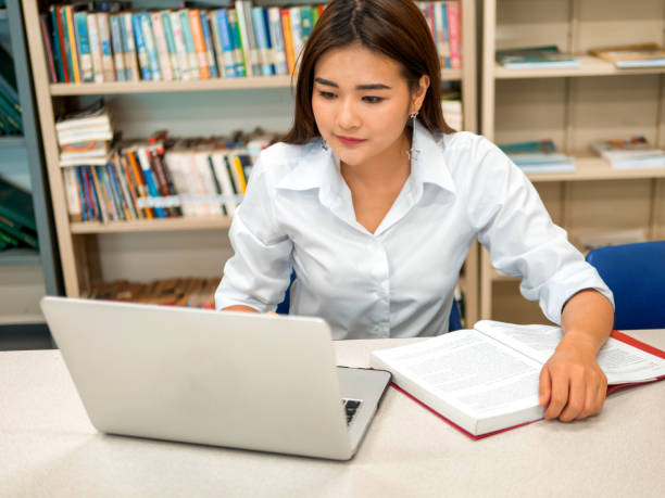 istock Asian students Reading and researching on the study in the library or learning center 1143545027