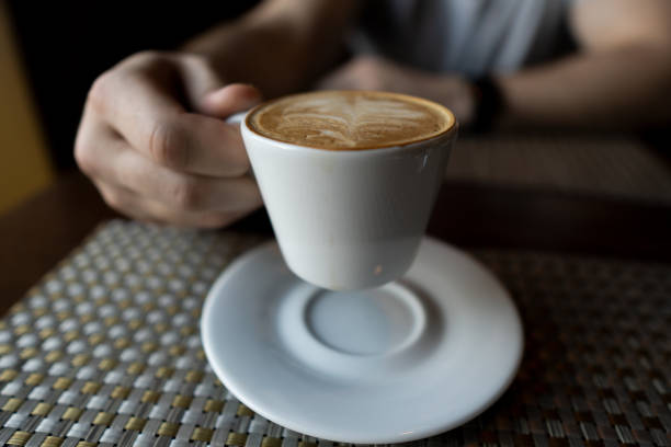 istock Male hand holding a white cup of coffee 1143546377
