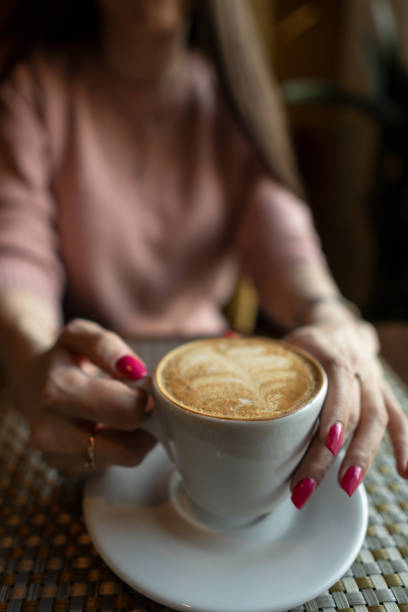 istock Female hand holding a white cup of coffee 1143546390
