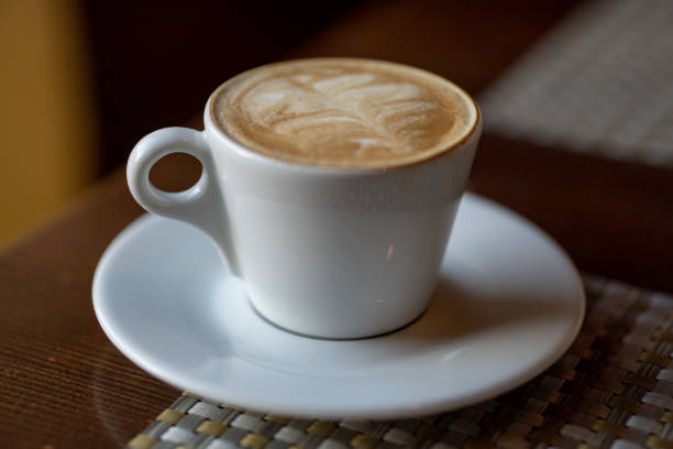 istock coffee in a white cup on the table. 1143546431