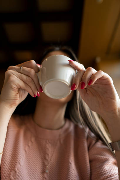 istock The girl drinks coffee in a cafe. 1143546436