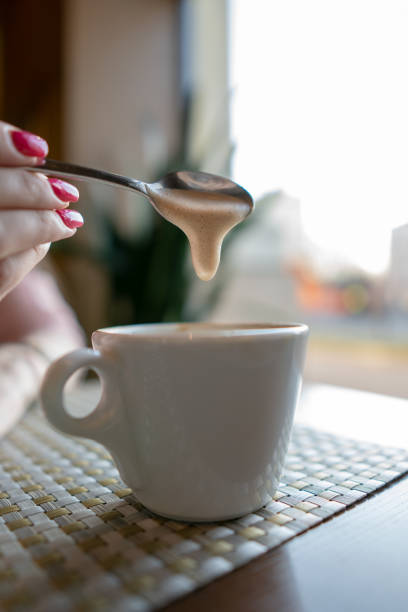 istock Female hand holding a white cup of coffee 1143546455
