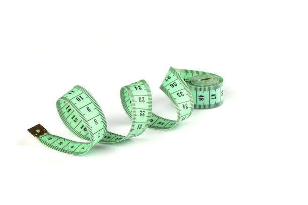 istock Tailoring centimeter tape twisted into a spiral isolated on a white background. 1143546632