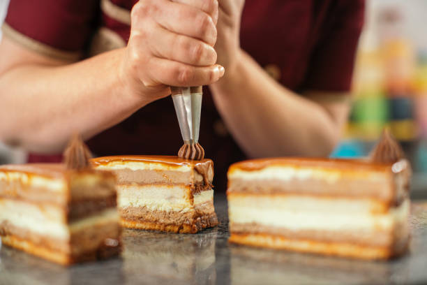 Woman making cakes in cake manufacture
