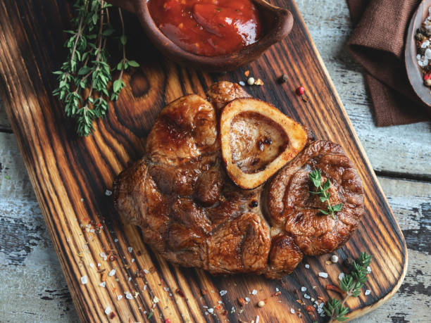 cooked Osso buco  Veal shank on a portion board closeup cooked Osso buco  Veal shank on a portion board closeup shin stock pictures, royalty-free photos & images