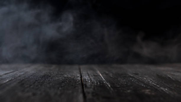 istock wooden table with dark smoky background . copy space 1143551033