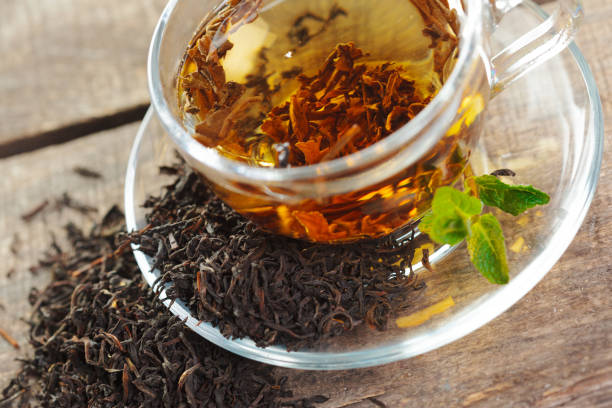 istock cup of black tea with mint leaves on a wooden table 1143552224