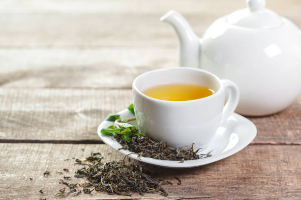 istock cup of black tea with mint leaves on a wooden table 1143552381