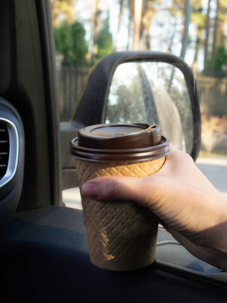 istock car coffee woman hand hold paper cup inside car 1143554514