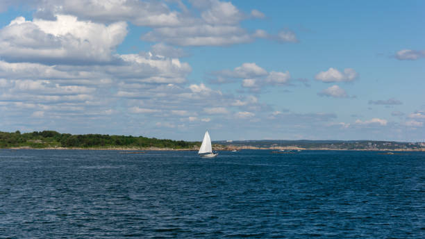 istock Water splash from moving boat and small island with green forest 1143556794