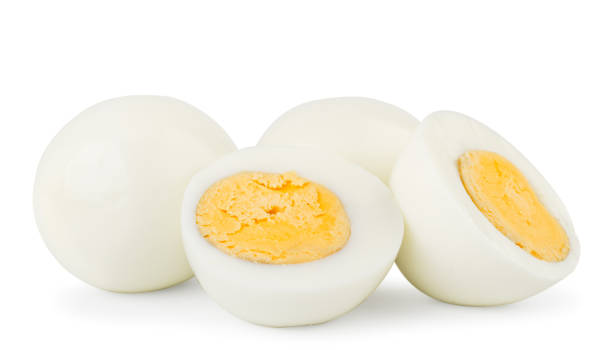 istock Boiled eggs and two halves close-up on a white. Isolated 1143556914