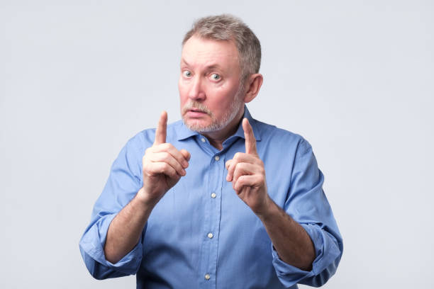 istock Man showing index fingers up, giving advice 1143558240