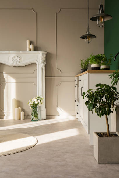 istock White fireplace portal with candles on grey wall of elegant kitchen 1143558711