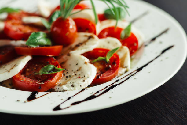 istock Appetizer with feta and tomatoes on dish 1143558873
