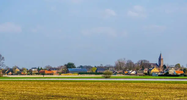 skyline of the village of Rucphen, a small rural village in North Brabant, The Netherlands, view from the pasture