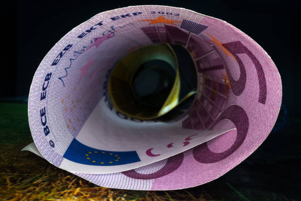 Inside the money tunnel. Abstract perspective view of euro back notes rolled in a tube. Saving and investing money Inside the money tunnel. Abstract perspective view of euro back notes rolled in a tube. Saving and investing money european union currency france number 50 coin stock pictures, royalty-free photos & images