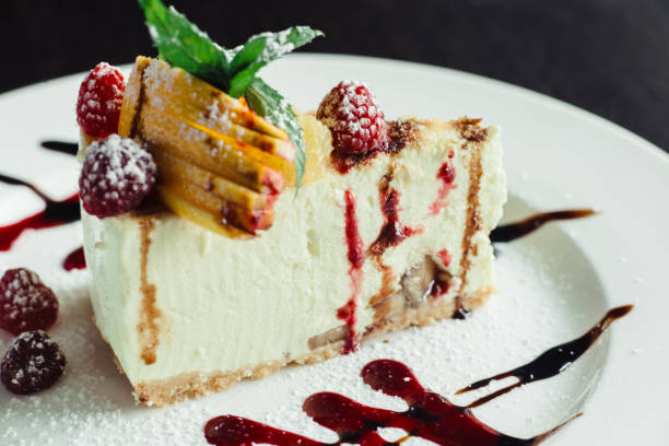istock Philadelphia cake with raspberries and orange slice on white dish 1143560798