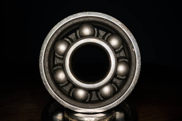 Macro shot of stainless steal bearing. New replacement roller skate bearings isolated on black background. Standard ABEC type bearing for inline skates, skateboard, long board or scooters Macro shot of stainless steal bearing. New replacement roller skate bearings isolated on black background. Standard ABEC type bearing for inline skates, skateboard, long board or scooters roller ball stock pictures, royalty-free photos & images